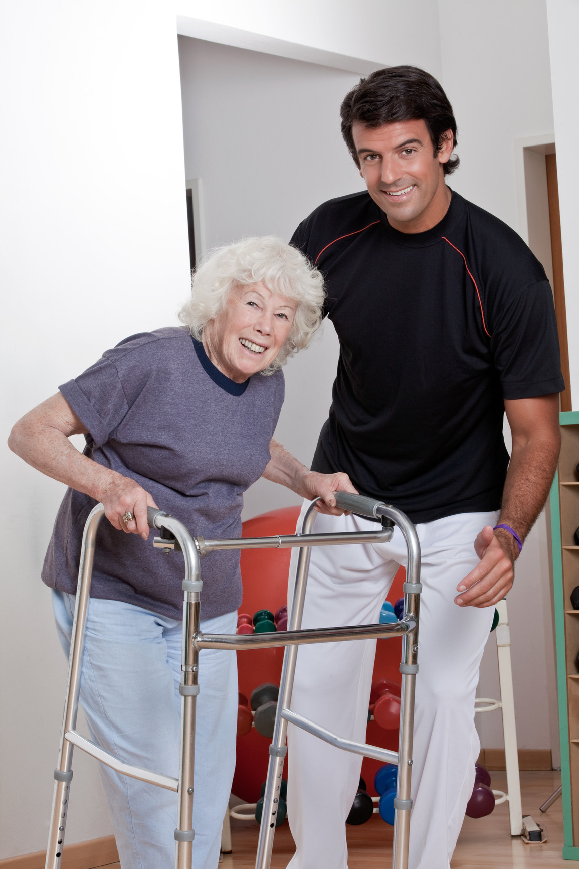 Therepaist helping patient with a walker