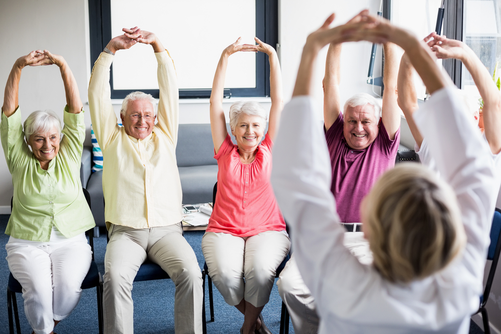 Group of happy seniors exercising